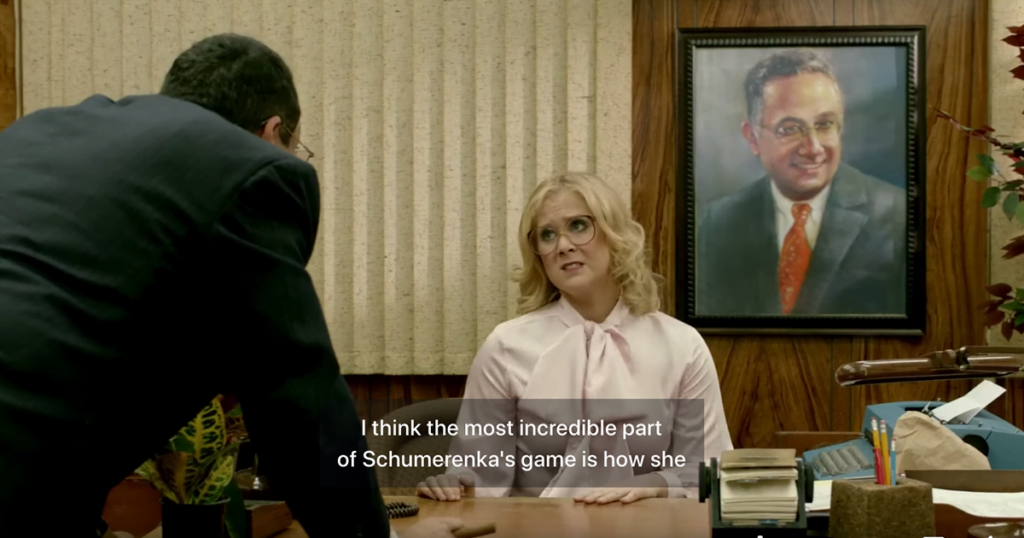A screenshot from the Inside Amy Schumer sketch 1970s Secretary. The caption is from a sketch about a tennis match.