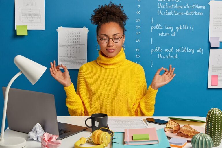woman practicing mindfulness and yoga at work