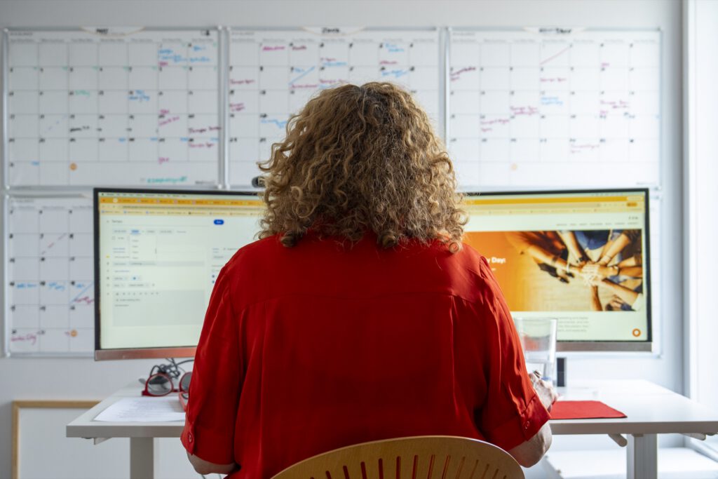 Team member reviewing a campaign dashboard in front of wall calendars