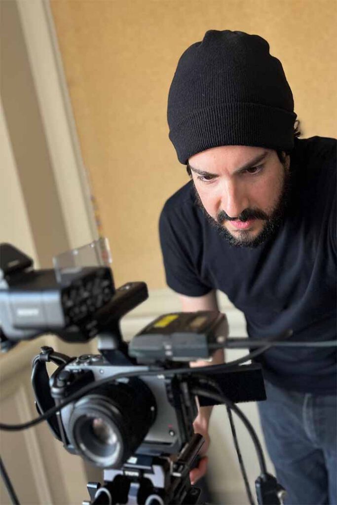 Camera operator filming with a professional video camera